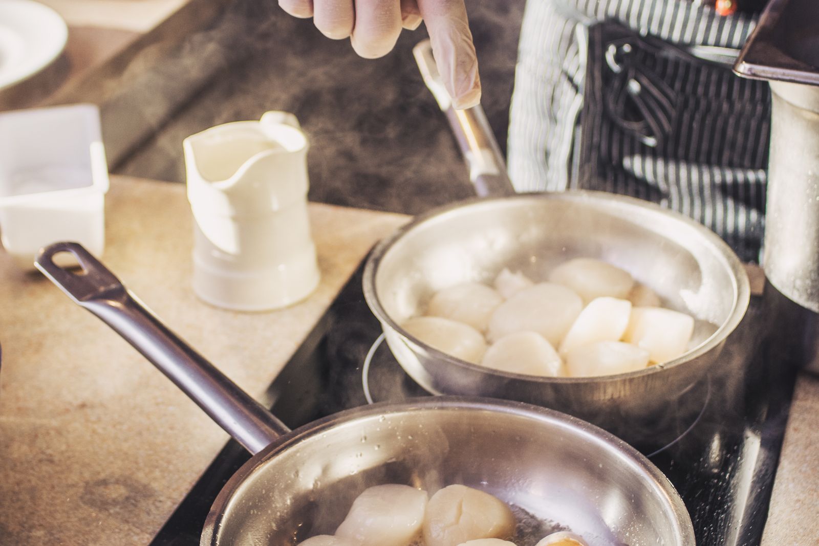 A sleek induction cooktop set into a modern stone countertop — Fisher & Paykel cooktop repair