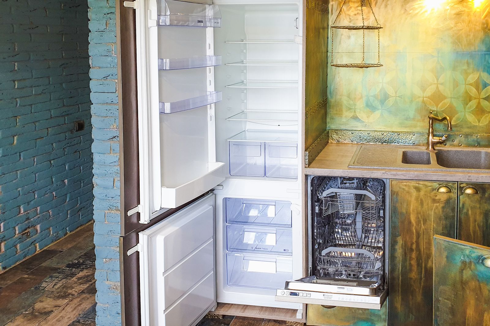 An open built-in dishwasher loaded with clean dishes — Fisher & Paykel dishwasher repair